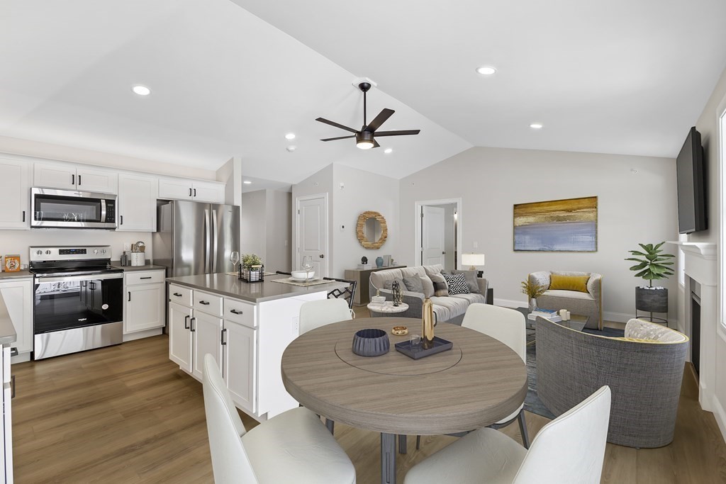 139 Harvard Street, Unit 10 Fitchburg, MA 01420 - Photo 3 of 11 a living room with furniture kitchen view and a fireplace