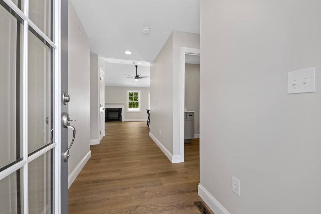 139 Harvard Street, Unit 10 Fitchburg, MA 01420 - Photo 5 of 11 a view of a hallway with wooden floor