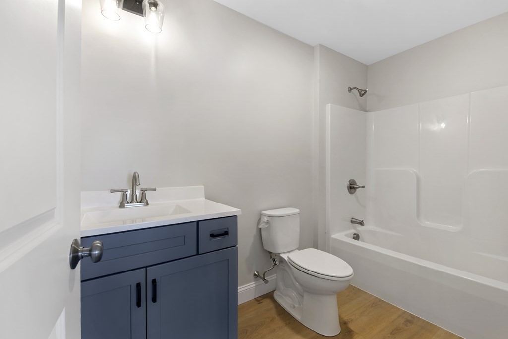 139 Harvard Street, Unit 10 Fitchburg, MA 01420 - Photo 8 of 11 a bathroom with a toilet a sink and bathtub