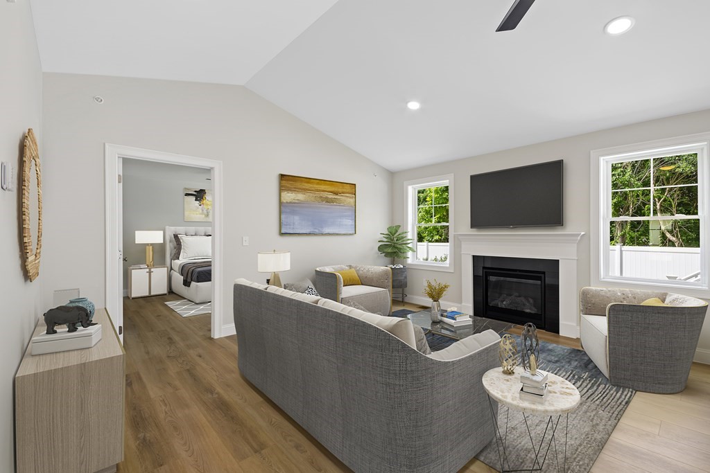 139 Harvard Street, Unit 10 Fitchburg, MA 01420 - Photo 9 of 11 a living room with furniture a fireplace and a flat screen tv