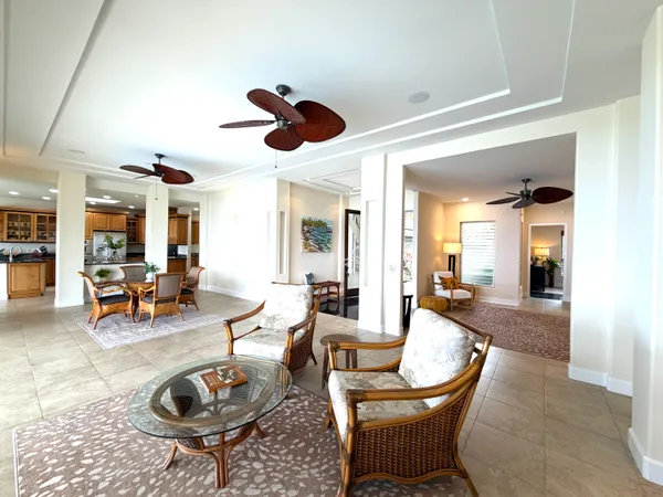 a living room with furniture a rug and a large window