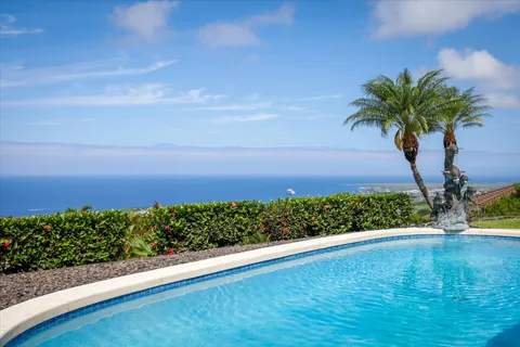 a view of a backyard with plants and lake view