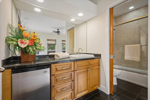 a bath tub sitting next to a blue sink