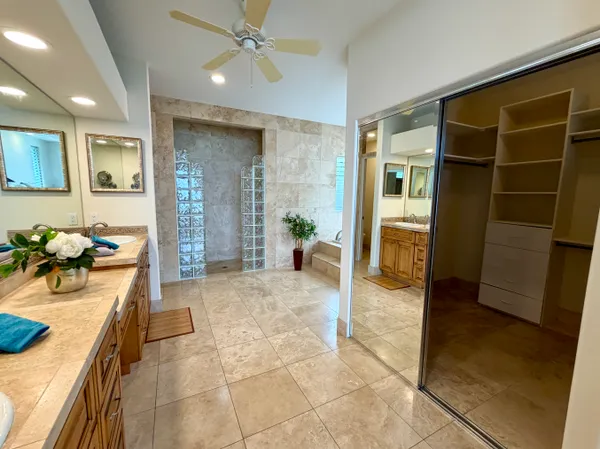 a living room with furniture a ceiling fan and a window