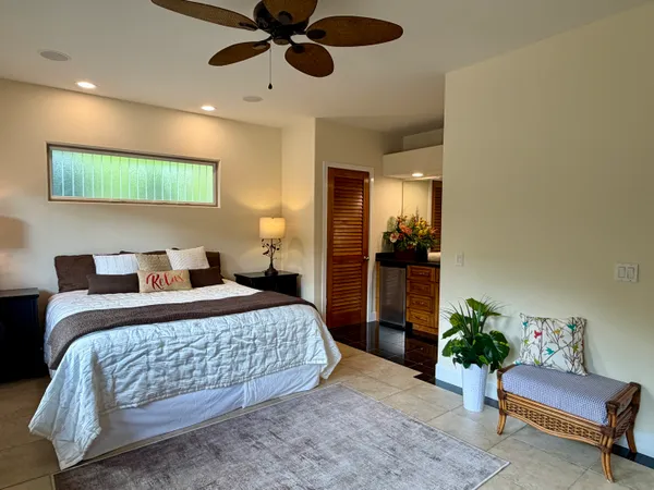 a bedroom with a bed and a couch