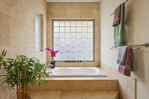 a utility room with granite countertop cabinets and washer