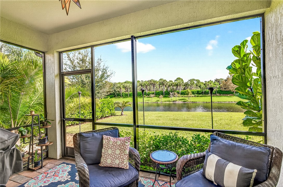 5191 Unity Square Vero Beach, FL 32967 - Photo 18 of 36 a living room with furniture and a floor to ceiling window