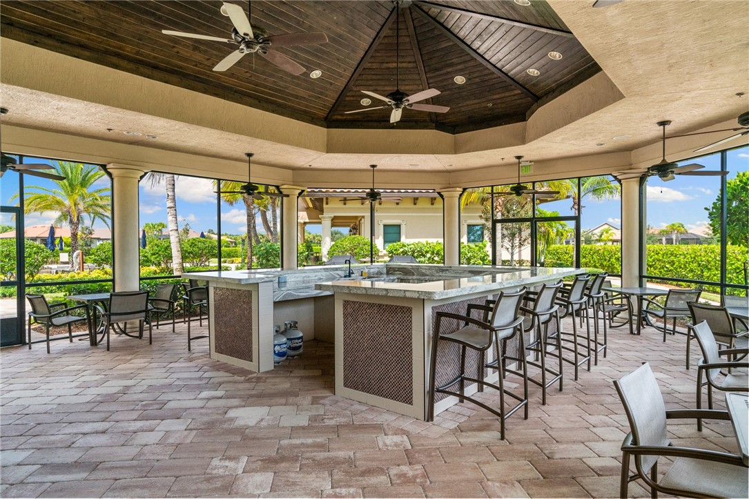 5191 Unity Square Vero Beach, FL 32967 - Photo 33 of 36 a outdoor space with lots of tables a large window and chairs