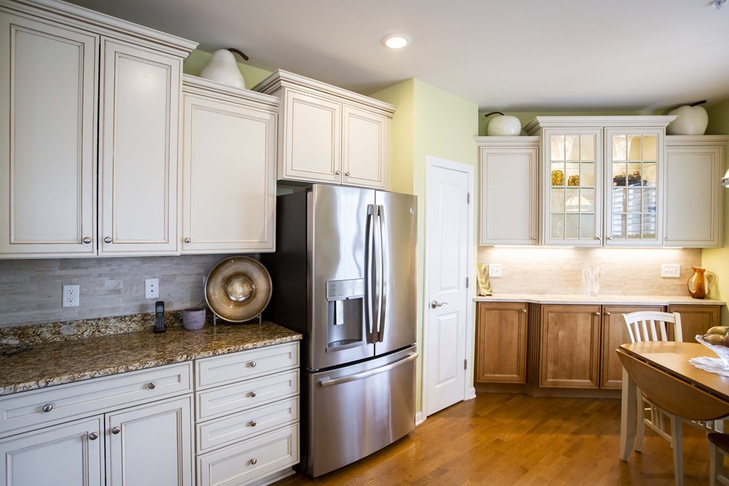 10 Abigail Way, Unit 3004 Reading, MA 01867 - Photo 17 of 32 a kitchen with stainless steel appliances granite countertop a refrigerator a stove and a sink