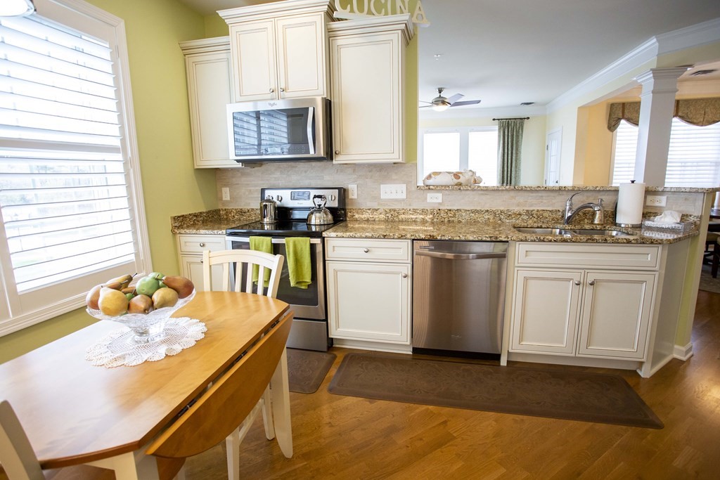 10 Abigail Way, Unit 3004 Reading, MA 01867 - Photo 18 of 32 a kitchen with a sink stove and white cabinets