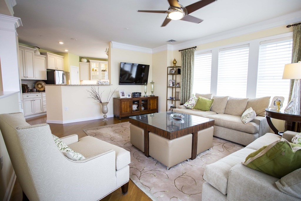 10 Abigail Way, Unit 3004 Reading, MA 01867 - Photo 22 of 32 a living room with furniture and a flat screen tv