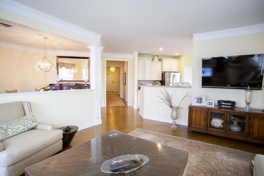 10 Abigail Way, Unit 3004 Reading, MA 01867 - Photo 23 of 32 a living room with furniture and a flat screen tv