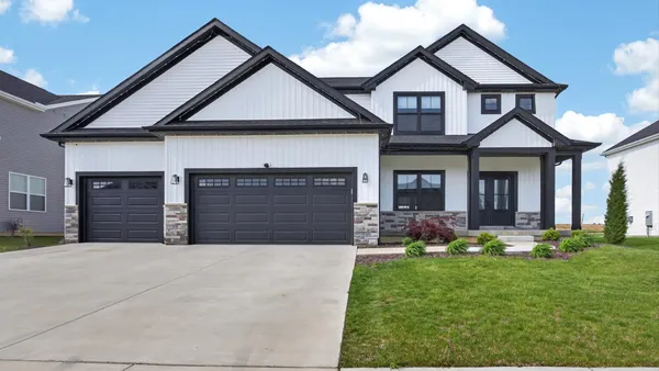 a front view of a house with a yard and garage