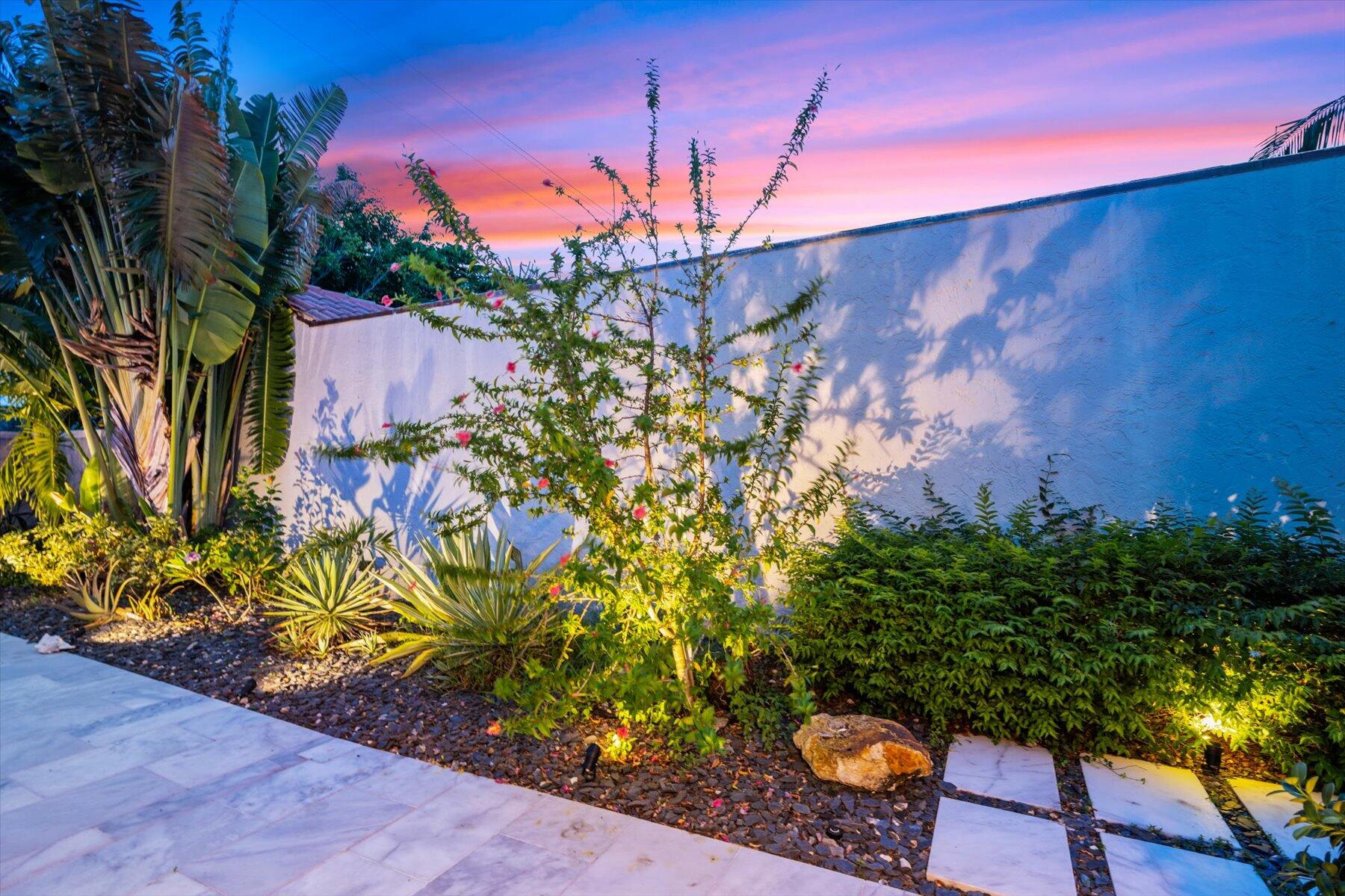 104 Sunfish Lane Jupiter, FL 33477 - Photo 50 of 66 a backyard of a house with lots of green space and outdoor seating