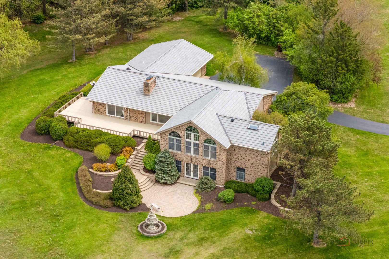 an aerial view of a house with garden space and street view