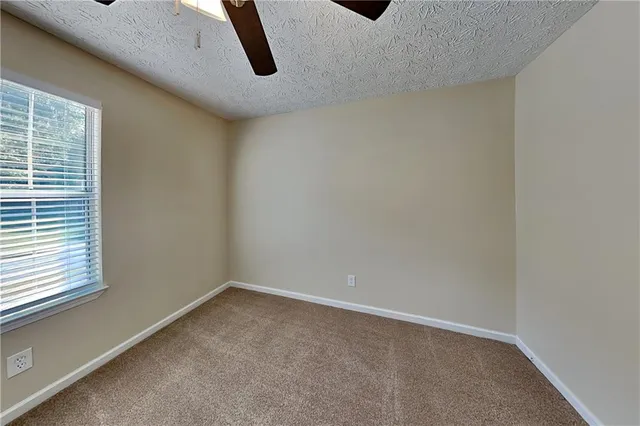 a view of a room with window and white walls