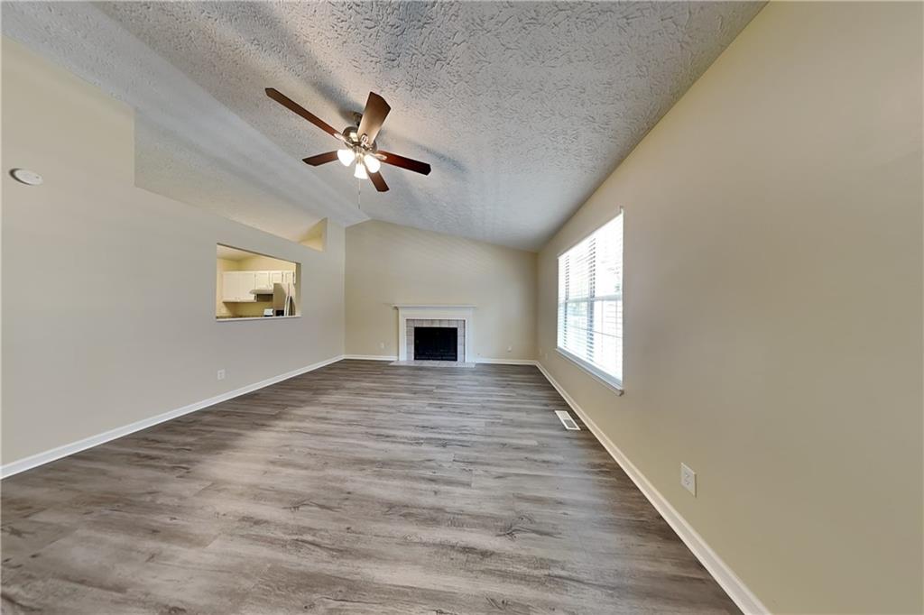 1049 Braddock Circle Woodstock, GA 30189 - Photo 2 of 20 wooden floor in an empty room with a window