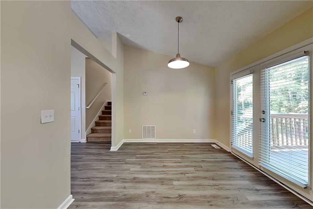 1049 Braddock Circle Woodstock, GA 30189 - Photo 5 of 20 a view of empty room with wooden floor and fan