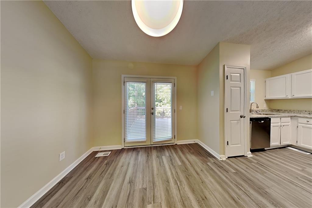 1049 Braddock Circle Woodstock, GA 30189 - Photo 6 of 20 an empty room with wooden floor and windows