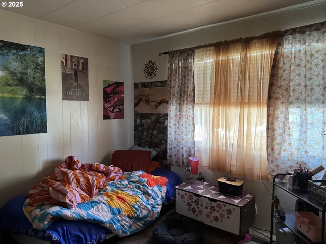 a bedroom with bed and a window