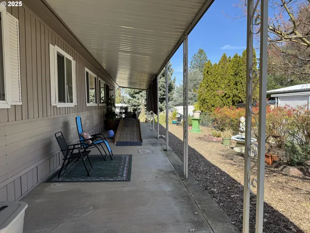 a view of a porch with furniture and a yard