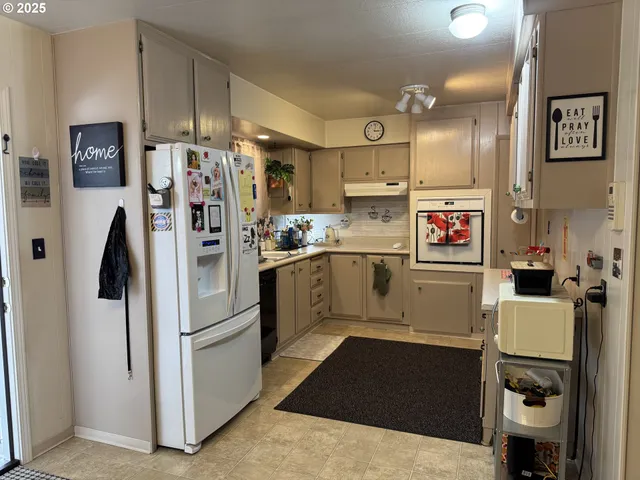 a kitchen with refrigerator and window