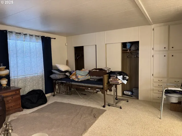 a living room with furniture a flat screen tv and a window