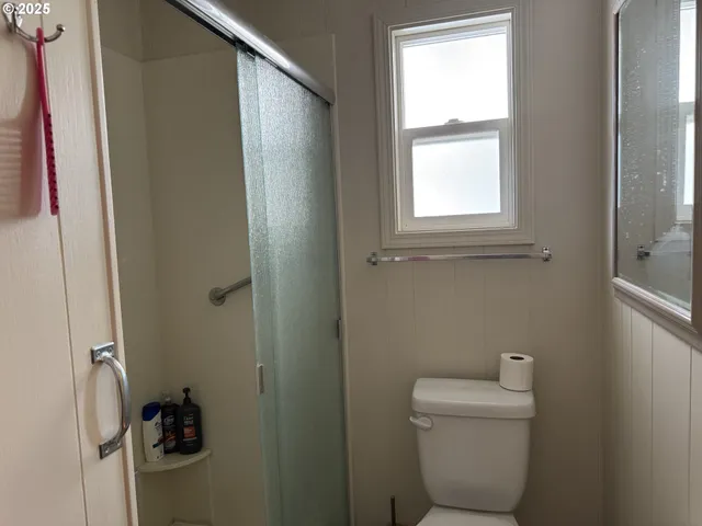 a bathroom with a toilet and a window