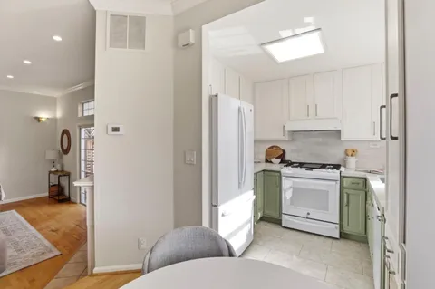 a kitchen with stainless steel appliances granite countertop a refrigerator and a stove
