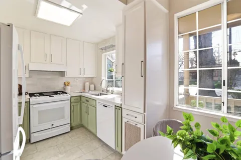a kitchen with stainless steel appliances white cabinets and a stove