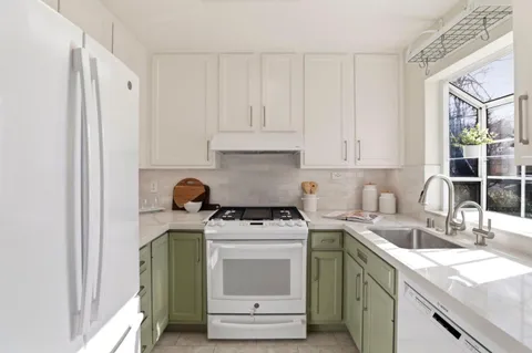 a kitchen with a stove a sink and a refrigerator
