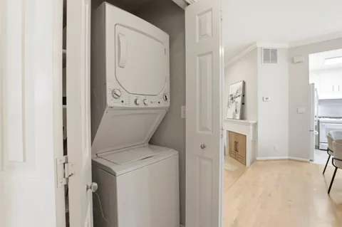 a view of washer and dryer with kitchen in the background