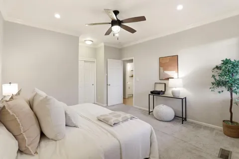a bedroom with bed and a chandelier