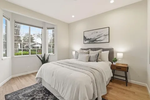 a bedroom with a large bed and a window