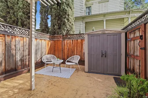 a backyard of a house with table and chairs