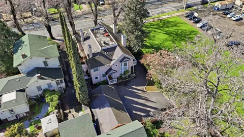 an aerial view of a house with a yard