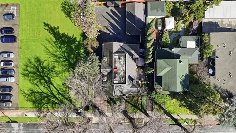an aerial view of a house with a yard