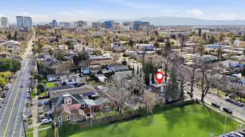 an aerial view of residential houses with outdoor space and swimming pool