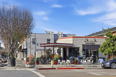 a view of a food mall next to a road