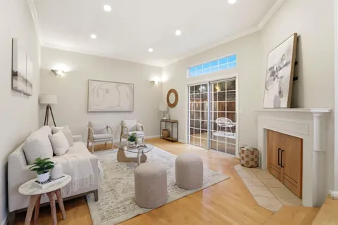 a living room with fireplace furniture and a fireplace