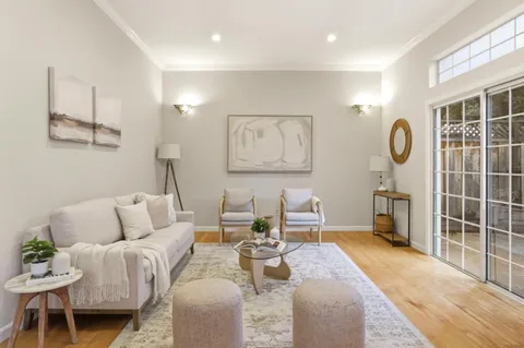 a living room with furniture a rug and white walls