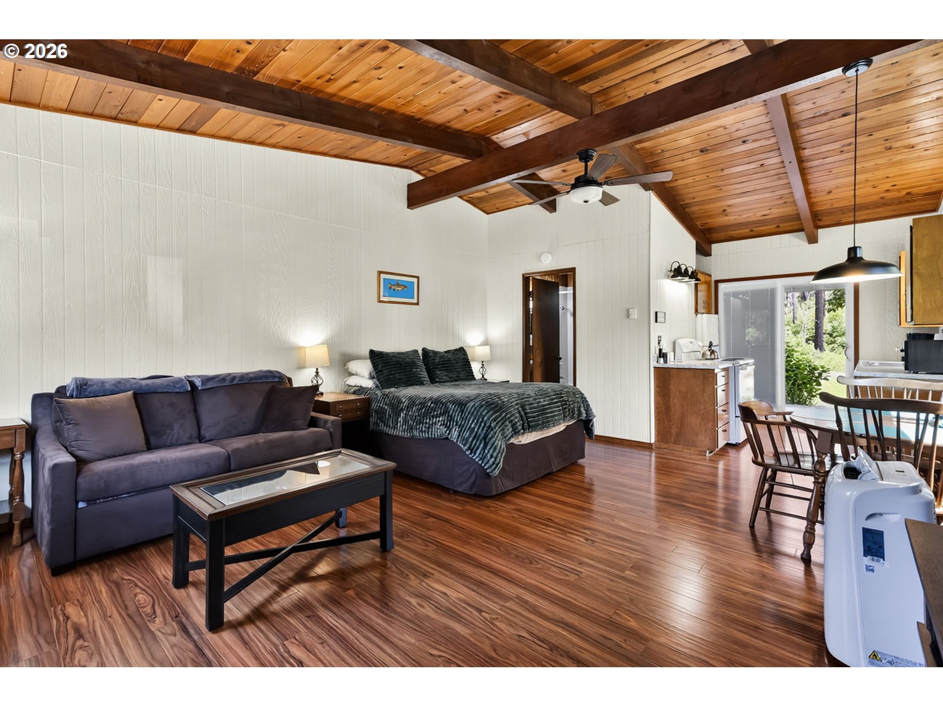 46725 Goodpasture Road Vida, OR 97488 - Photo 23 of 48 a living room with furniture a wooden floor and next to a window