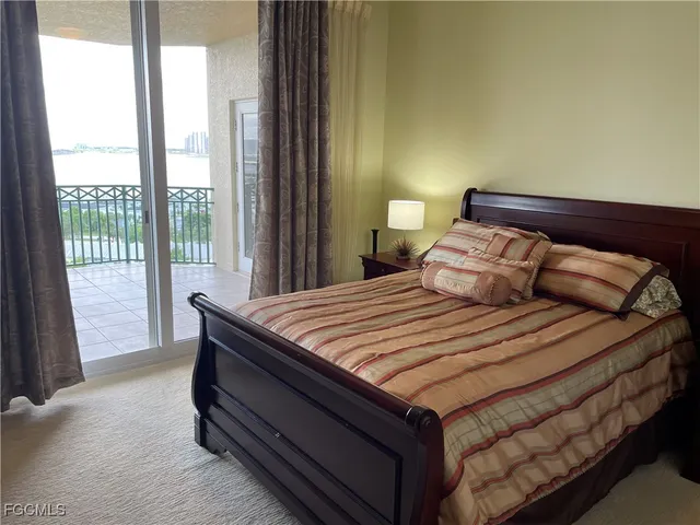 a bedroom with a bed and a large window