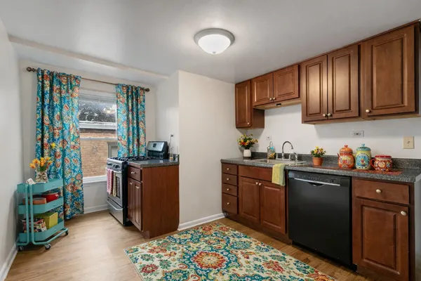 a kitchen with stainless steel appliances granite countertop a refrigerator stove and sink