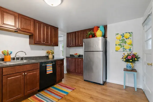 a kitchen with a refrigerator and a sink