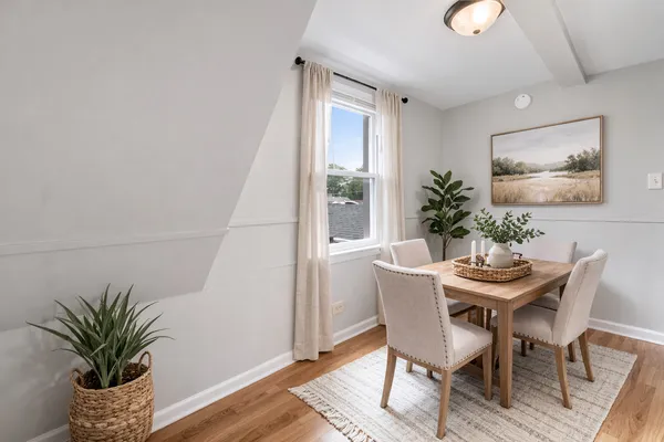 a dining room with furniture and wooden floor