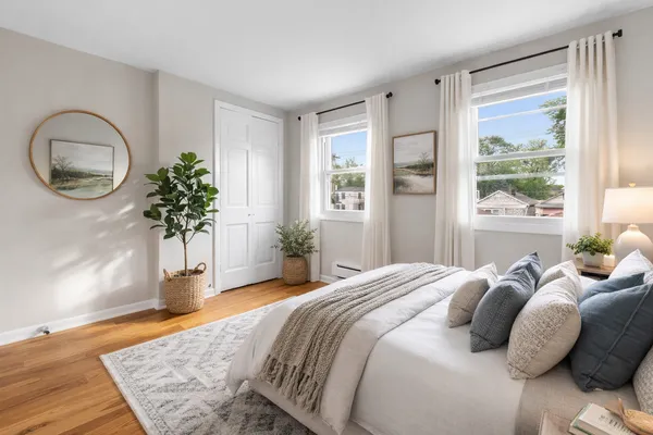 a bedroom with a bed and a potted plant