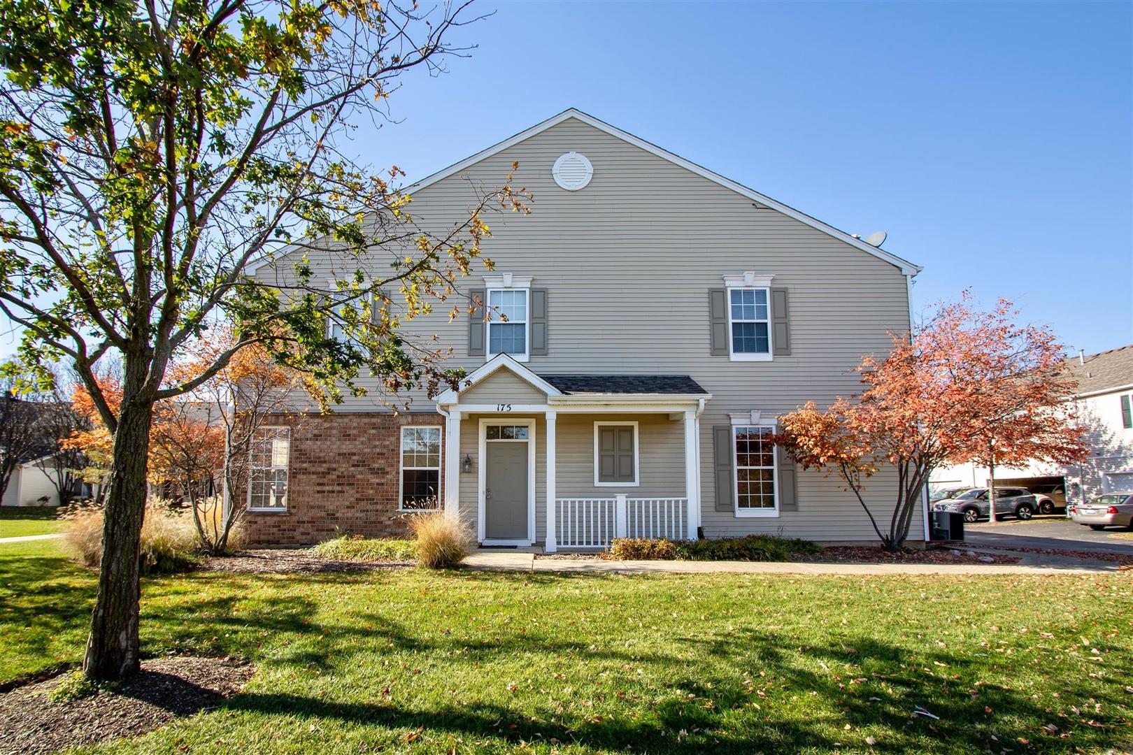 175 Springbrook Trail South Oswego, IL 60543 - Photo 1 of 25 a front view of a house with a yard and trees