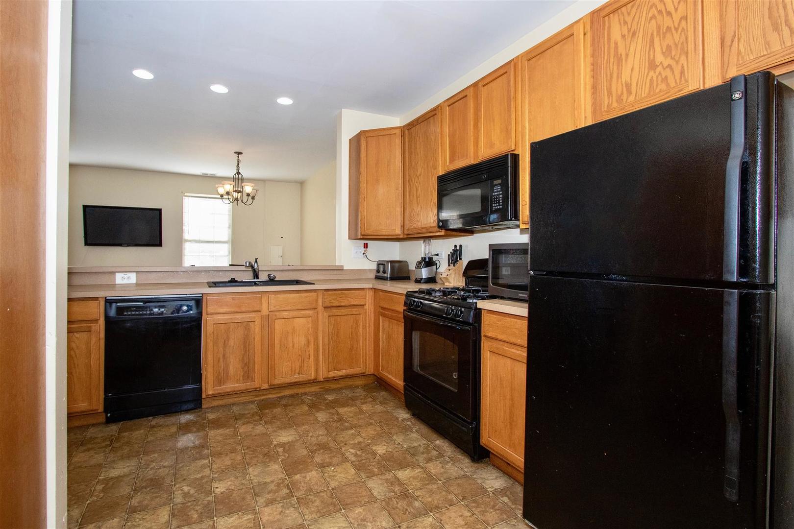 175 Springbrook Trail South Oswego, IL 60543 - Photo 2 of 25 a kitchen with granite countertop a refrigerator stove top oven and sink