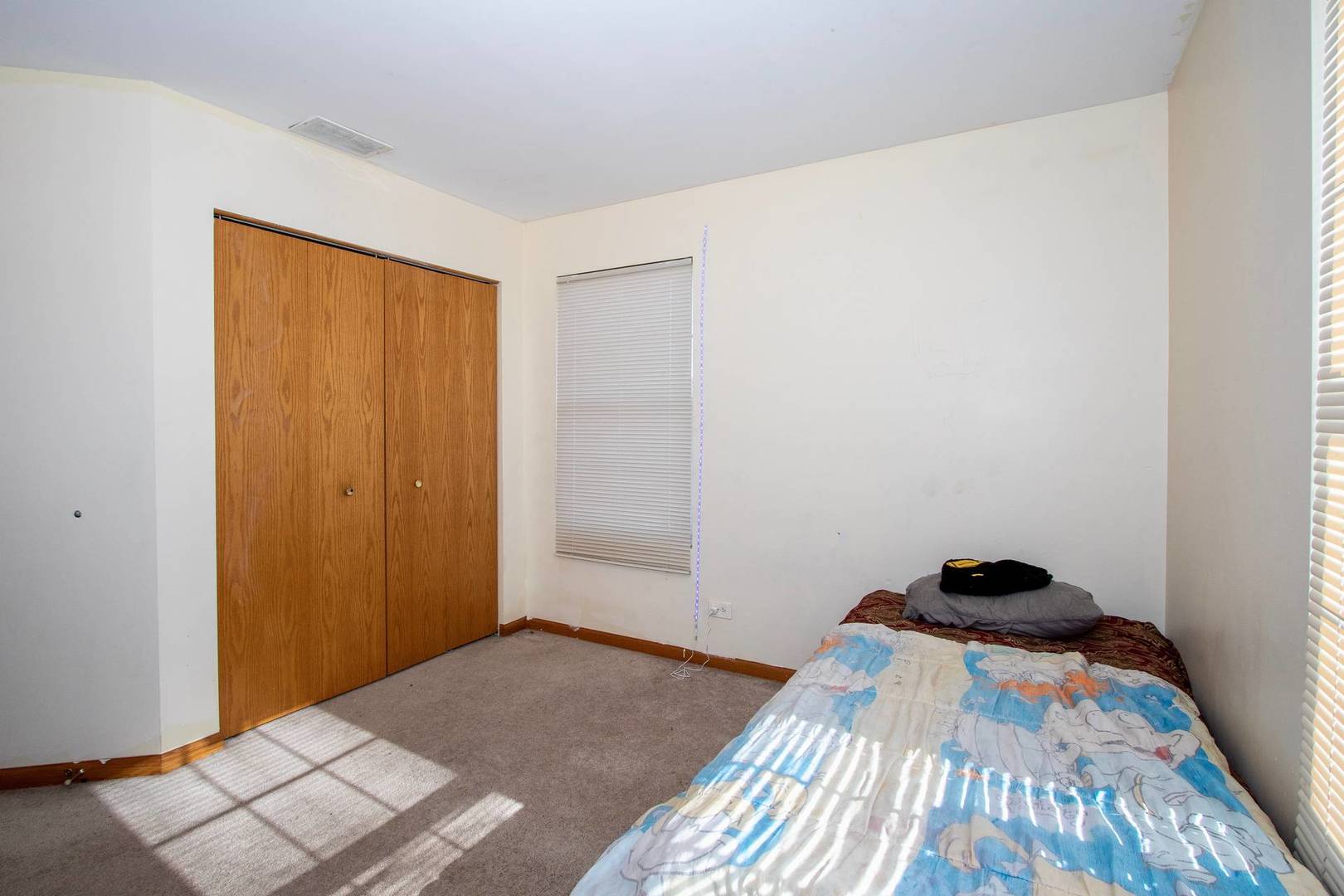175 Springbrook Trail South Oswego, IL 60543 - Photo 19 of 25 a bedroom with a bed and a window